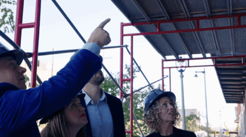 People in hard hats looking at a construction project.